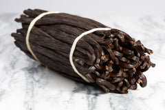 Kiddu split vanilla bean revealing black seeds and intense flavor benefit