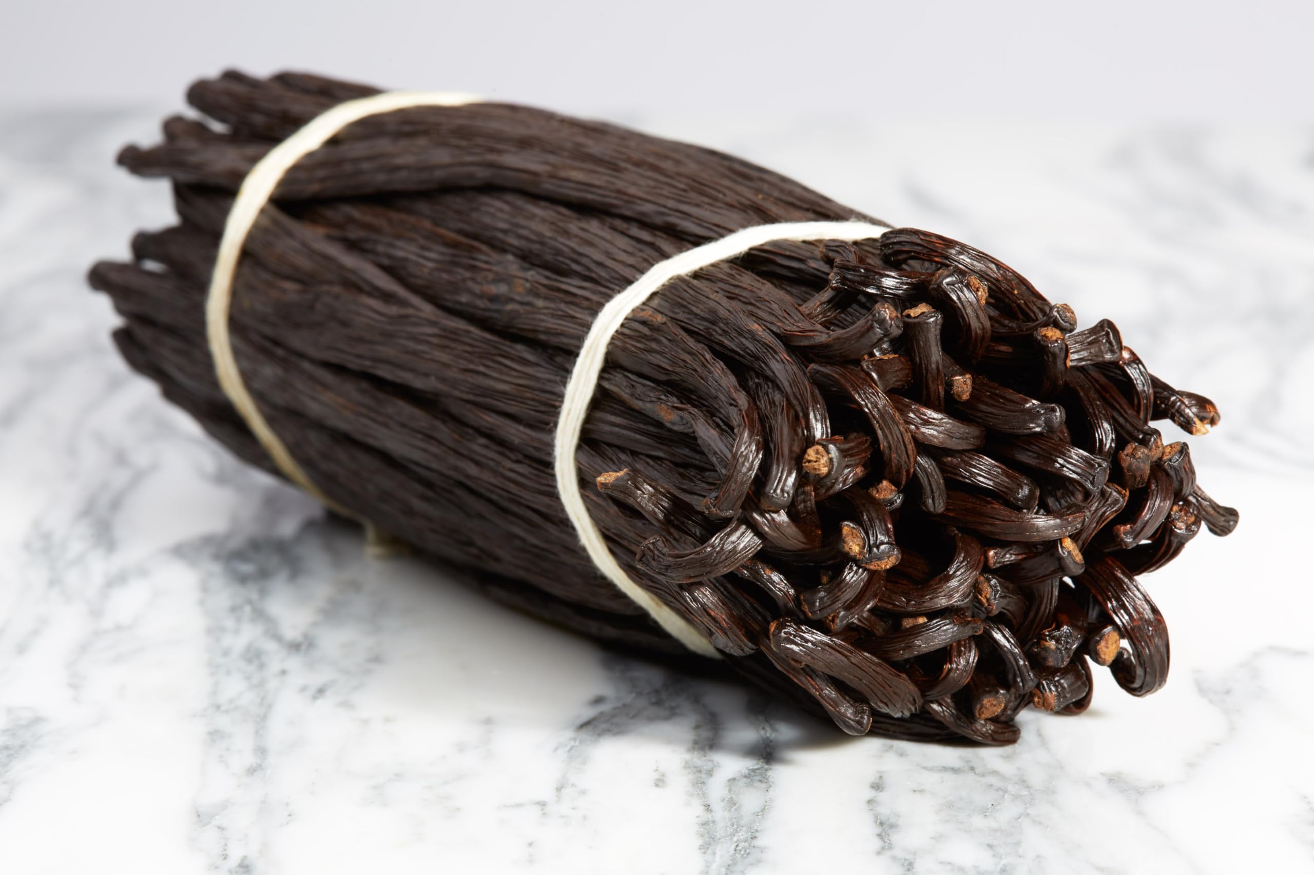 Kiddu close-up of scraped vanilla seeds showing rich flecks and enhanced flavor