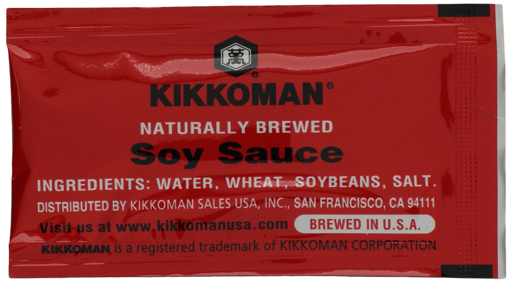 Kikkoman close-up of opened packet pouring soy sauce onto sushi for controlled seasoning