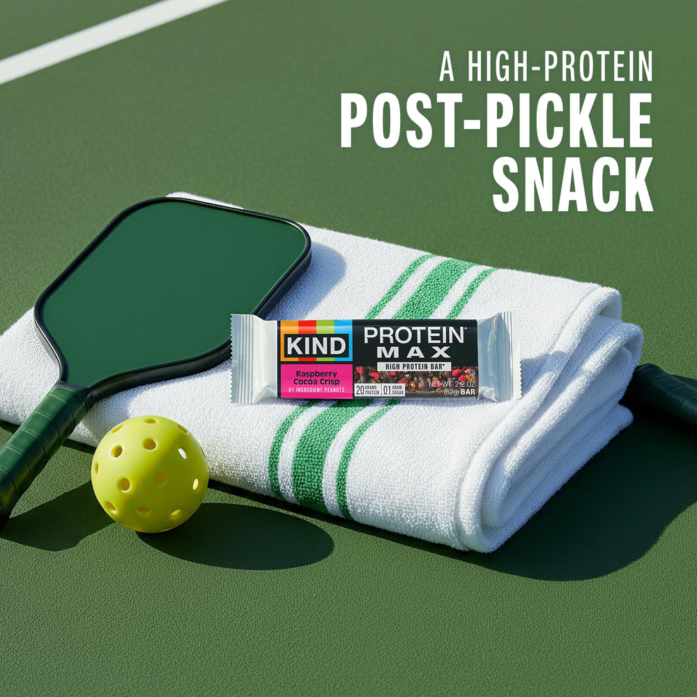 Hand holding KIND Protein MAX bar to show real-life size and portable benefit