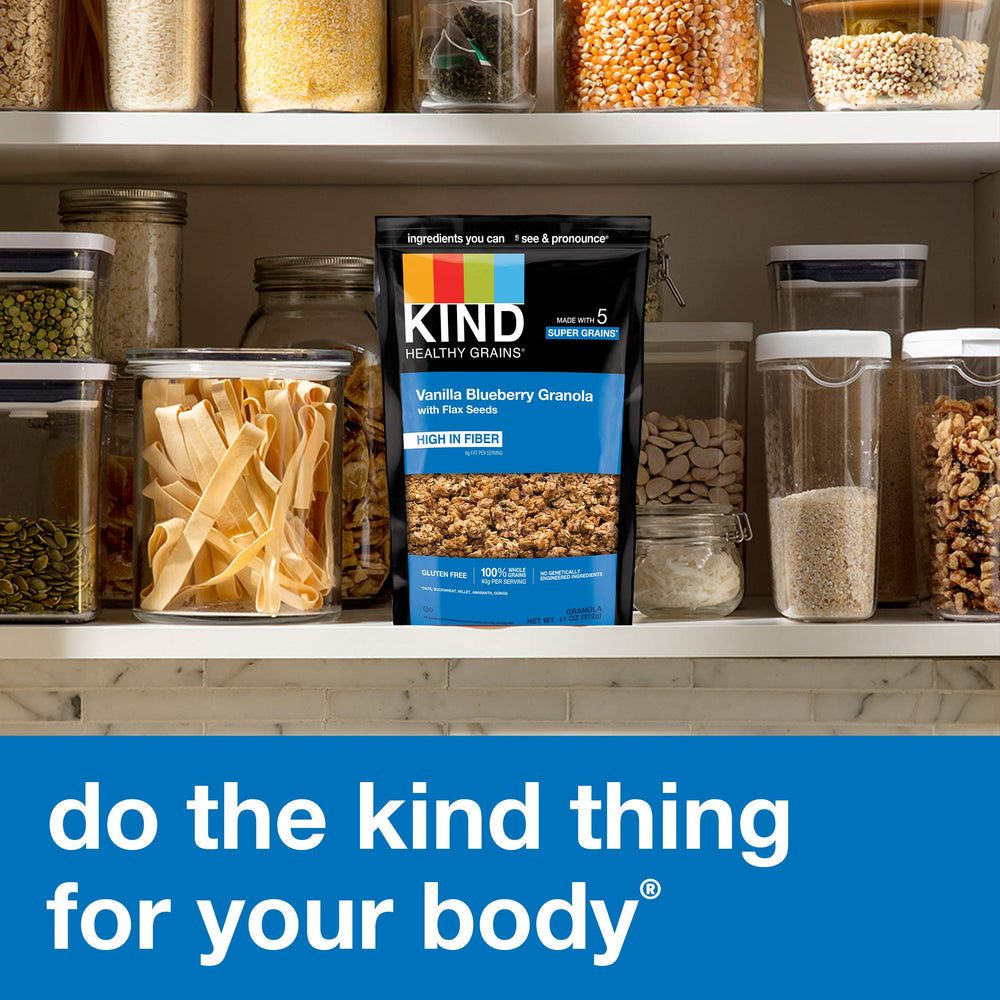 KIND hand holding 11oz bag showing compact size and grab-and-go convenience