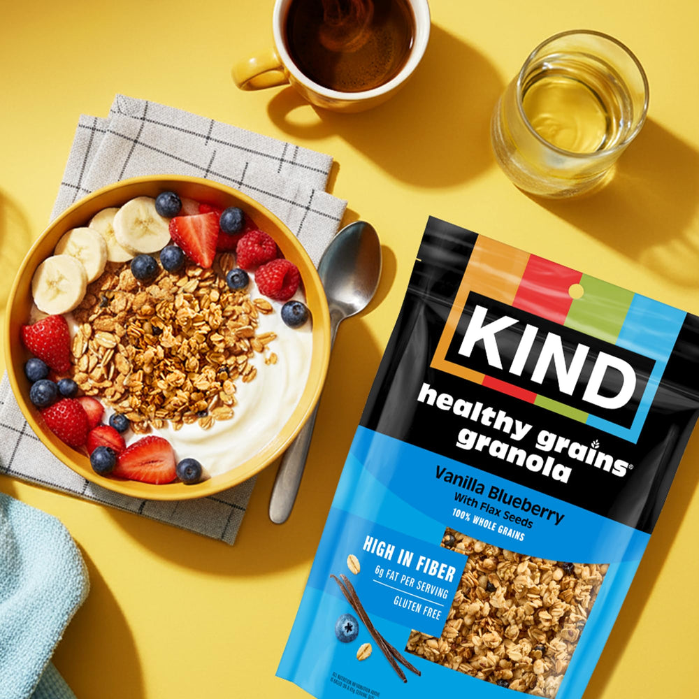 KIND spoonful of granola over yogurt showing added crunch and quick breakfast boost