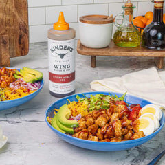 Kinder's bottle beside utensils to show 27.5 ounce scale and portioning