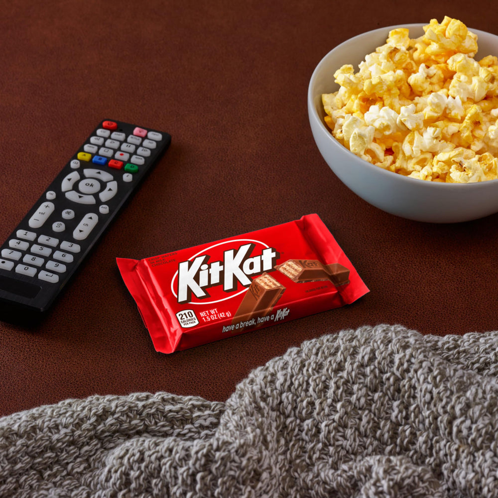 Kit Kat bar held in hand for scale showing single-serve portion