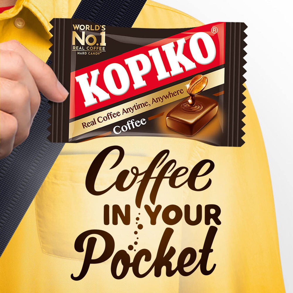 Kopiko candies beside a passport and phone, ideal for travelers needing quick caffeine