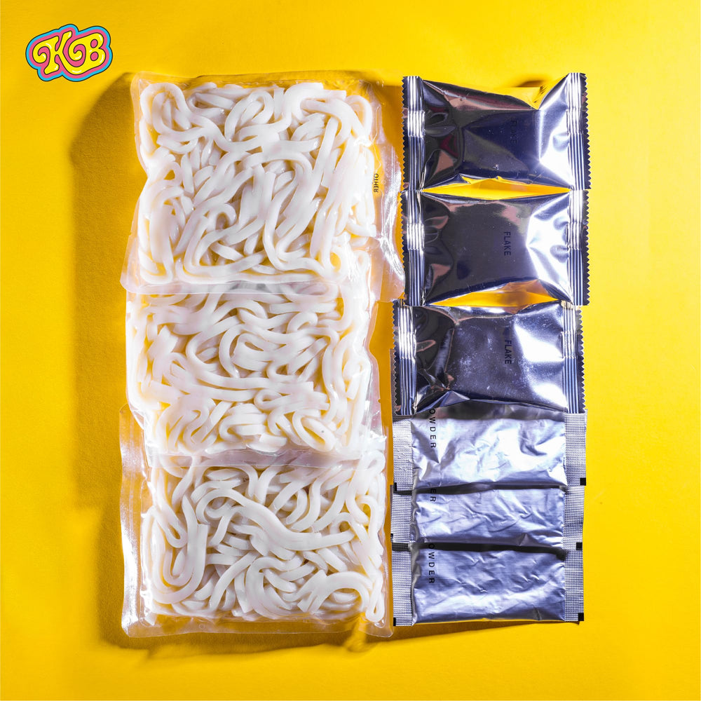 Korean Bros udong pack beside common objects showing three-serving scale