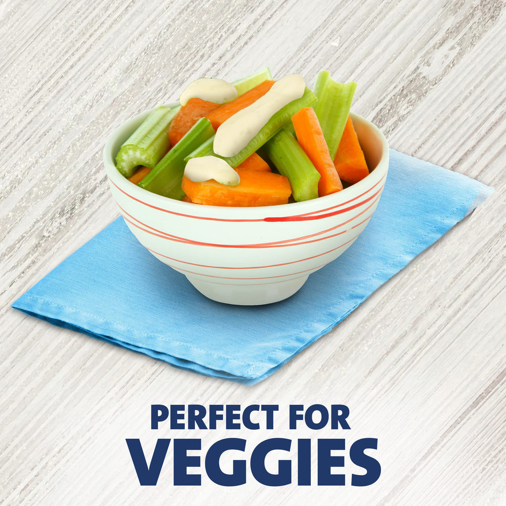 Good Seasons Kraft packet atop a salad showing easy dressing application and presentation