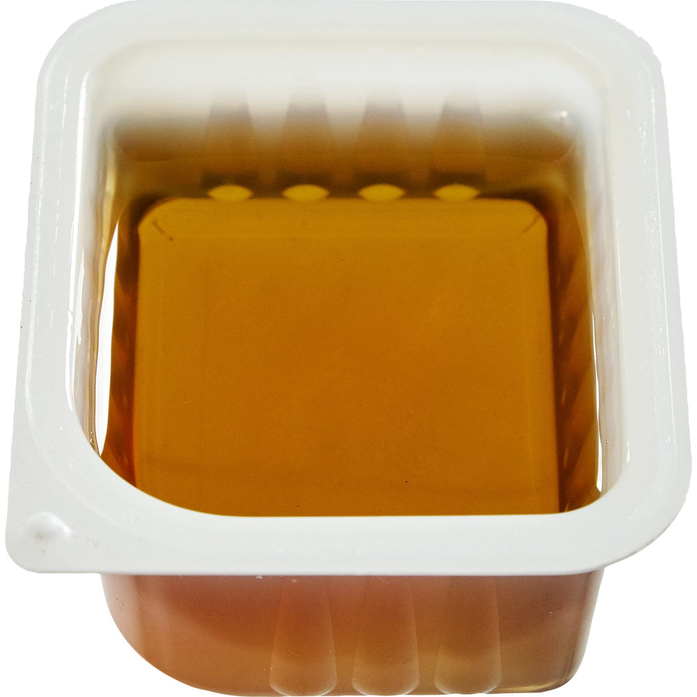 Kraft syrup cup poured over pancakes in plate setting illustrating guest-ready presentation