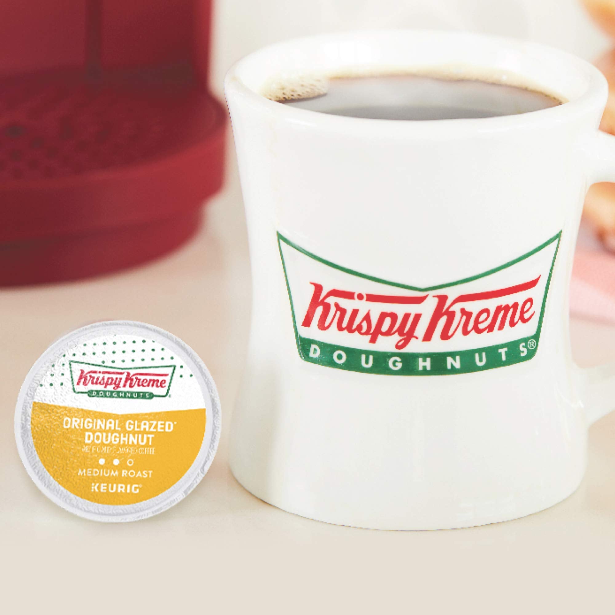 Krispy Kreme coffee cup beside an original glazed doughnut, pairs with pastries