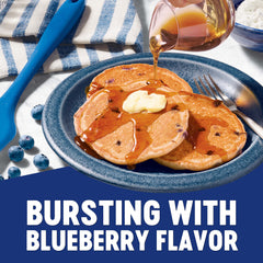 Krusteaz blueberry pancake stack plated with syrup demonstrating fluffy texture