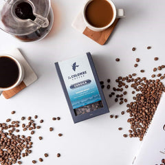 Top view of opened La Colombe Corsica bag with beans ready to grind for freshness