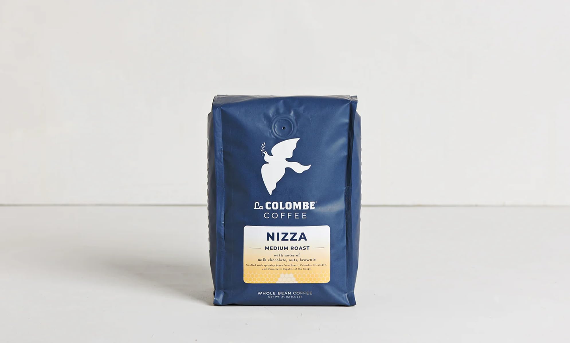 La Colombe latte in a café-style setting demonstrating creamy milk pairing