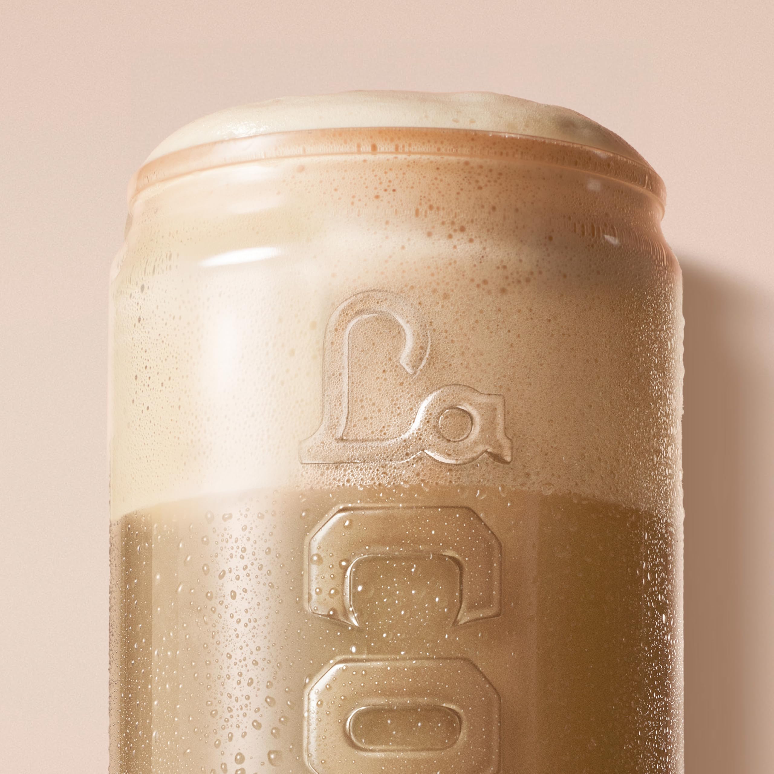 La Colombe can held in hand illustrating 9 fl oz single-serve portability