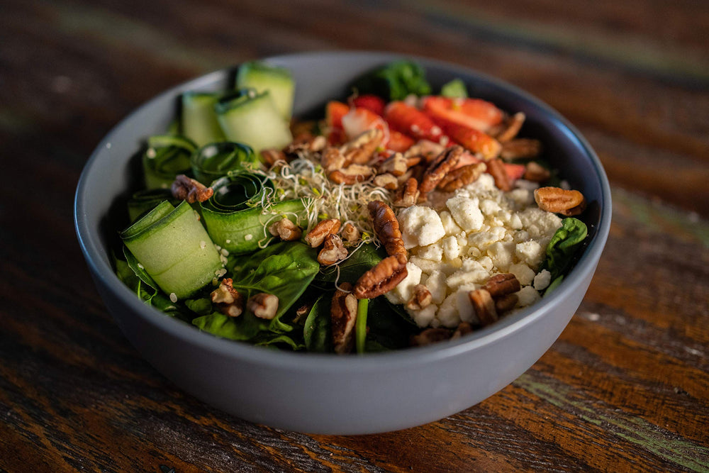 Grupo La Nogalera pecan halves sprinkled on salad adding crunch and nutrition