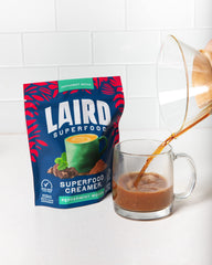 Laird Superfood pouring into coffee to add peppermint mocha flavor