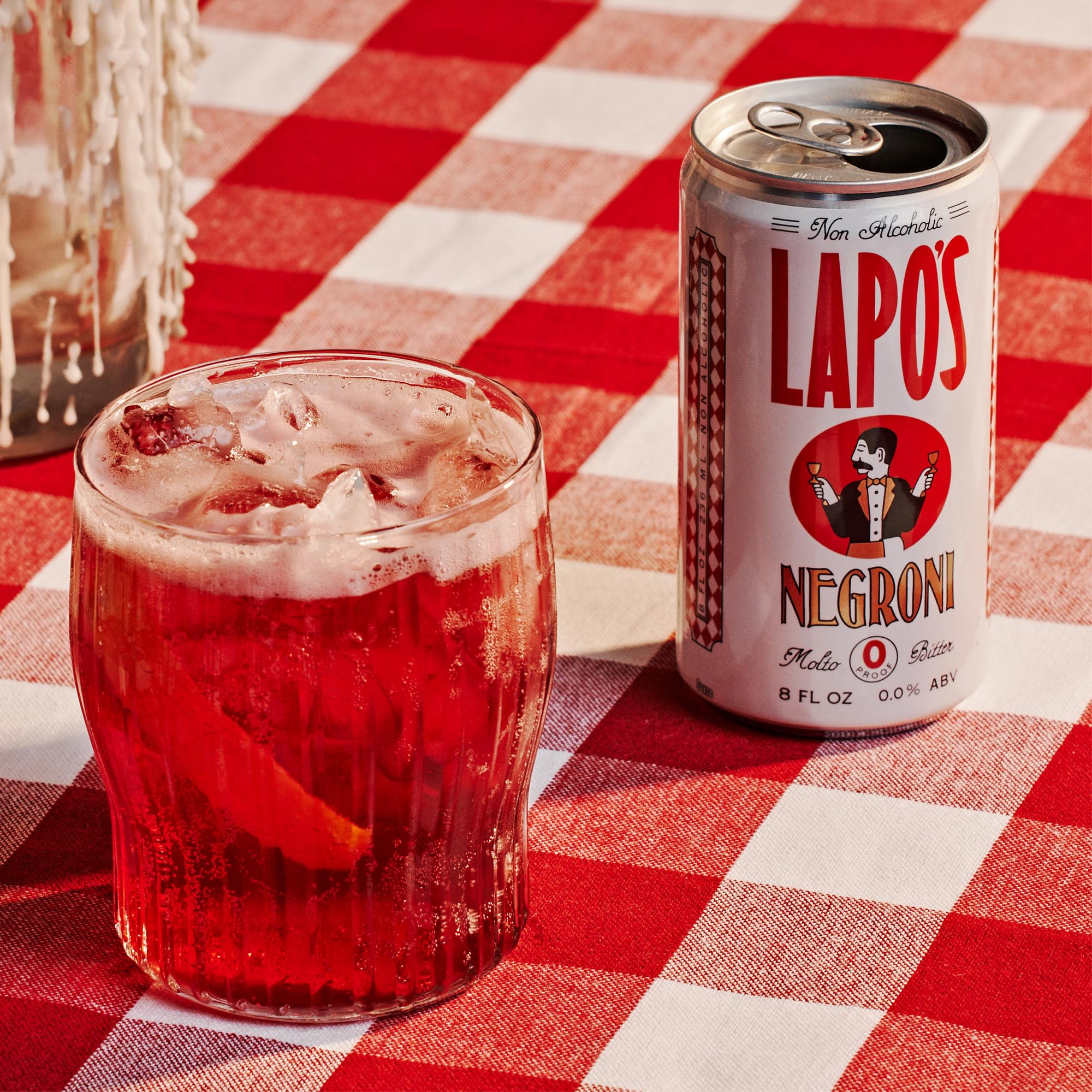 Lapo's can poured over ice with orange garnish enhancing aroma
