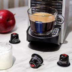 Lavazza espresso shot pouring from machine showing rich crema and immediate enjoyment