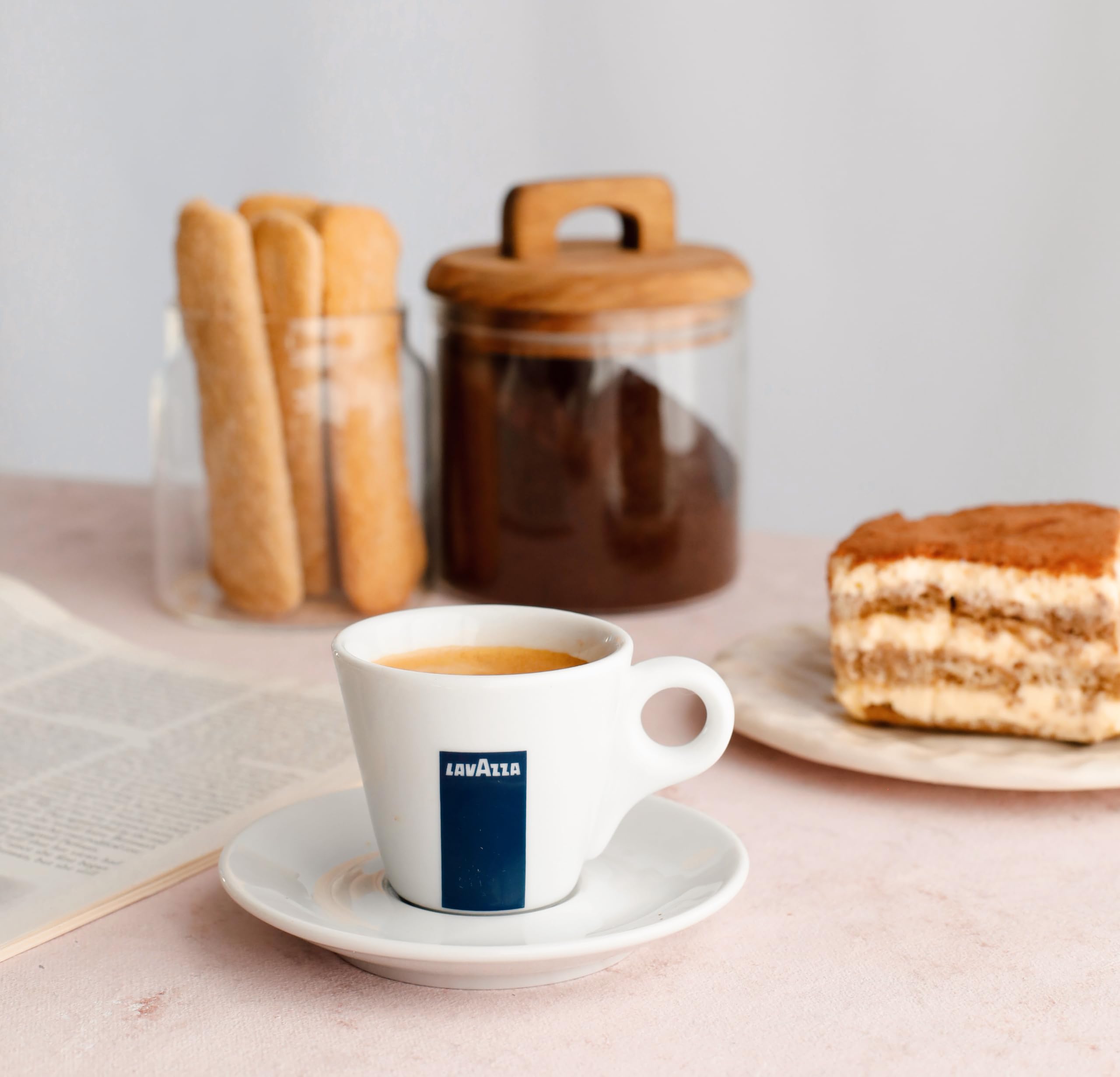 Lavazza DEK on wooden table lifestyle scene conveying premium Italian ritual