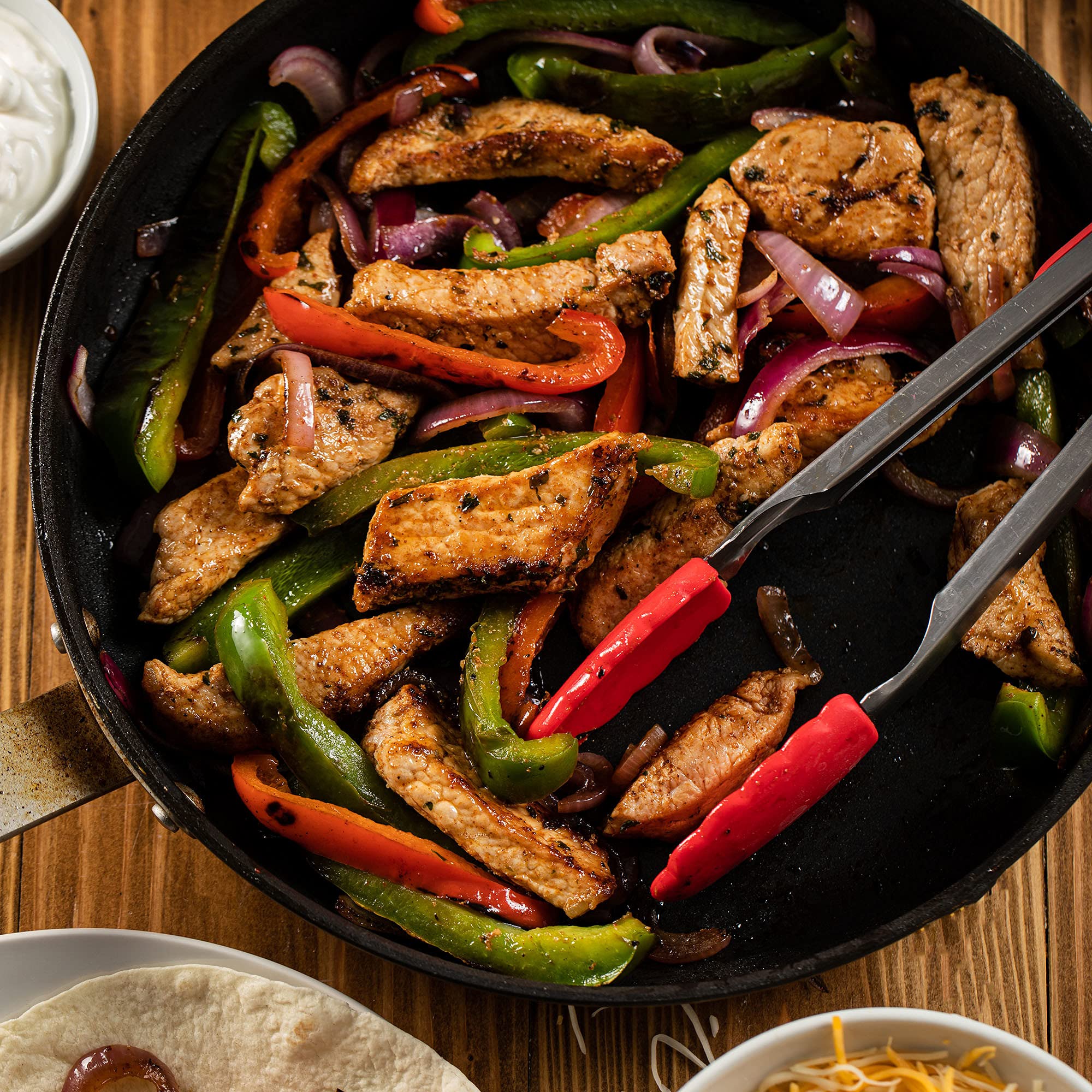 Lawry's seasoned chicken sizzling in pan, delivers restaurant-style fajitas