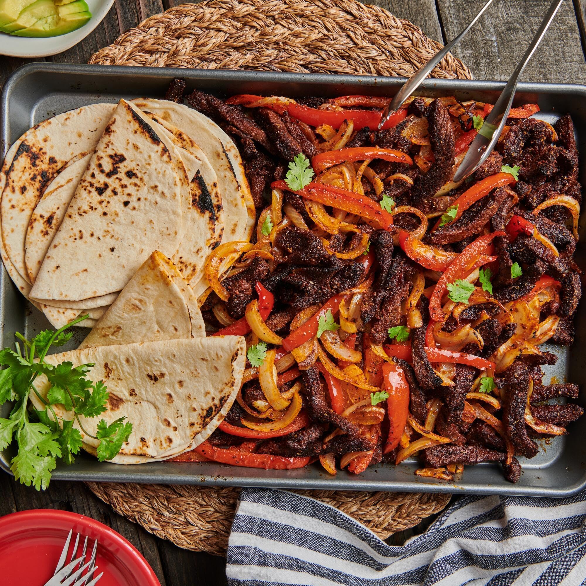 Skillet of sizzling fajitas with Lawry's seasoning, speeds up weeknight meals