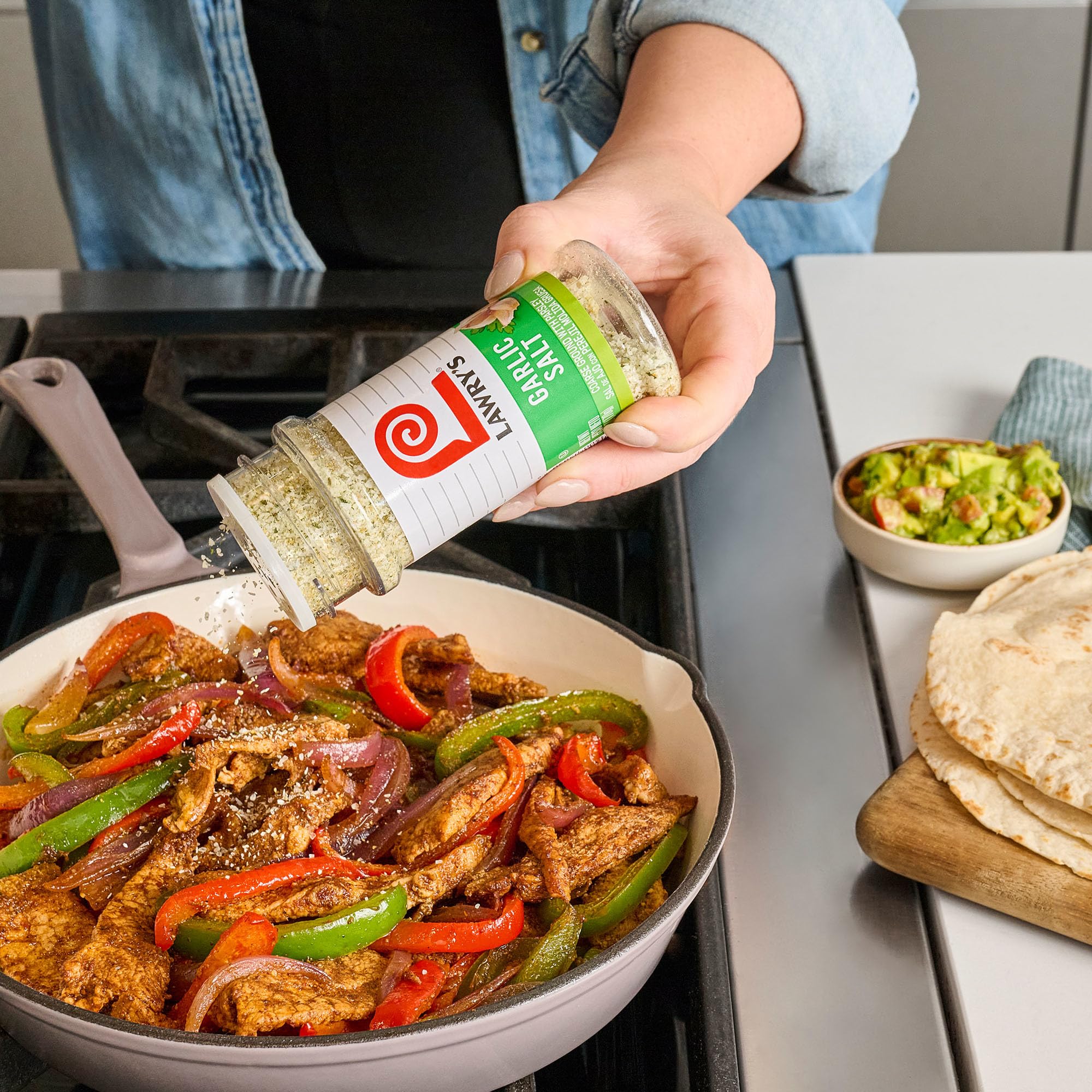 Lawry's in hand for scale to illustrate the 6 oz jar size