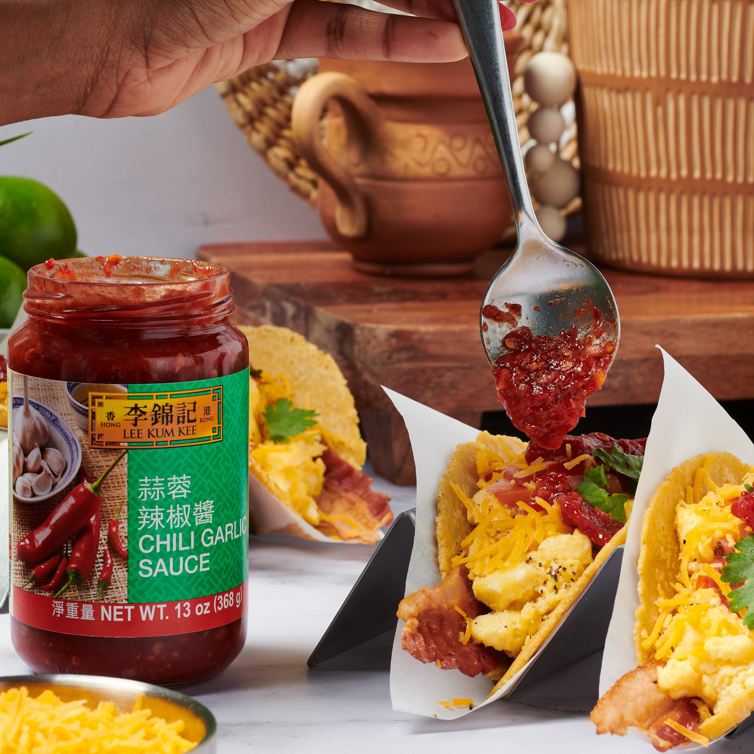 Lee Kum Kee in a dipping bowl beside dumplings offering spicy dipping convenience