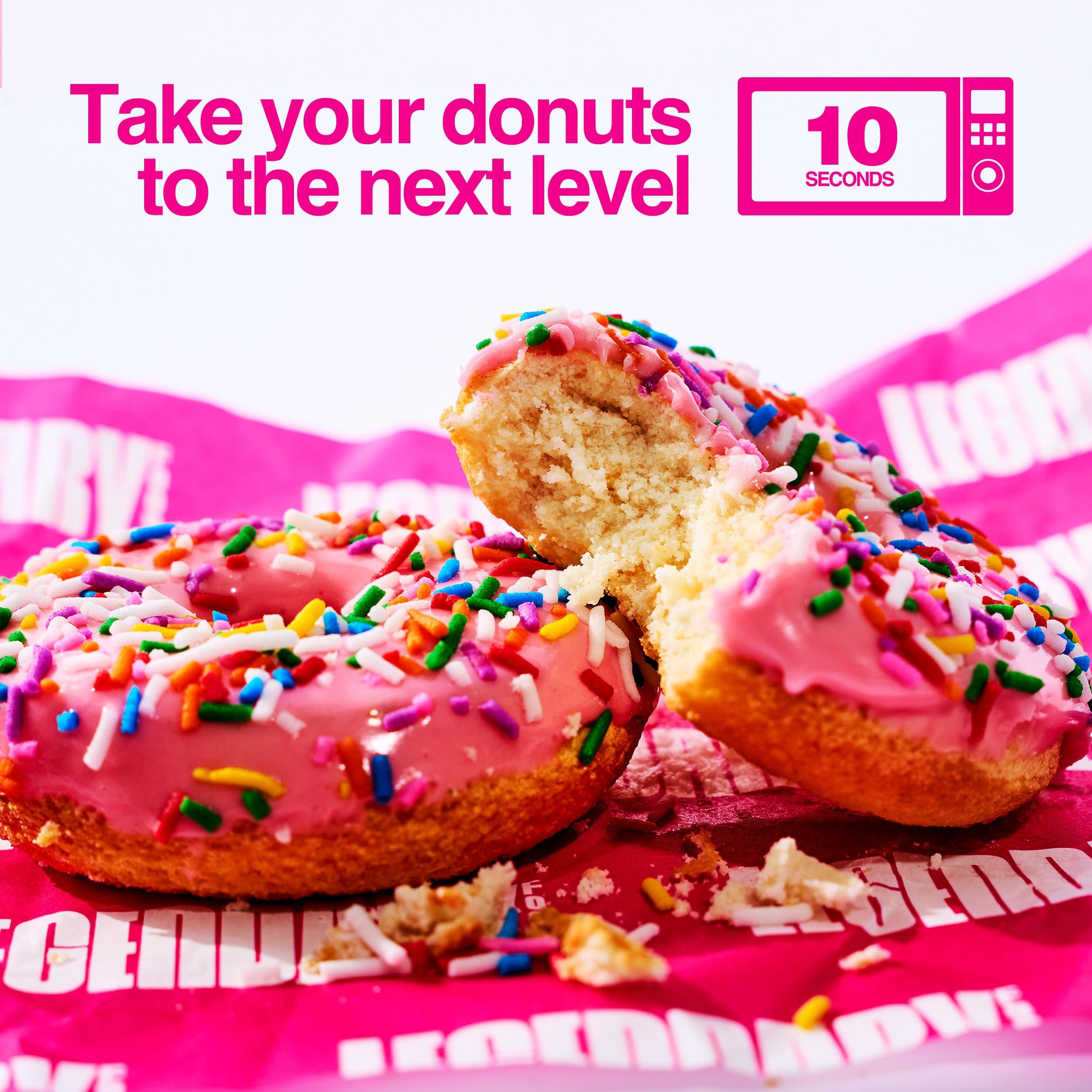 Legendary Foods warmed pink sprinkle donut on plate with melted glaze