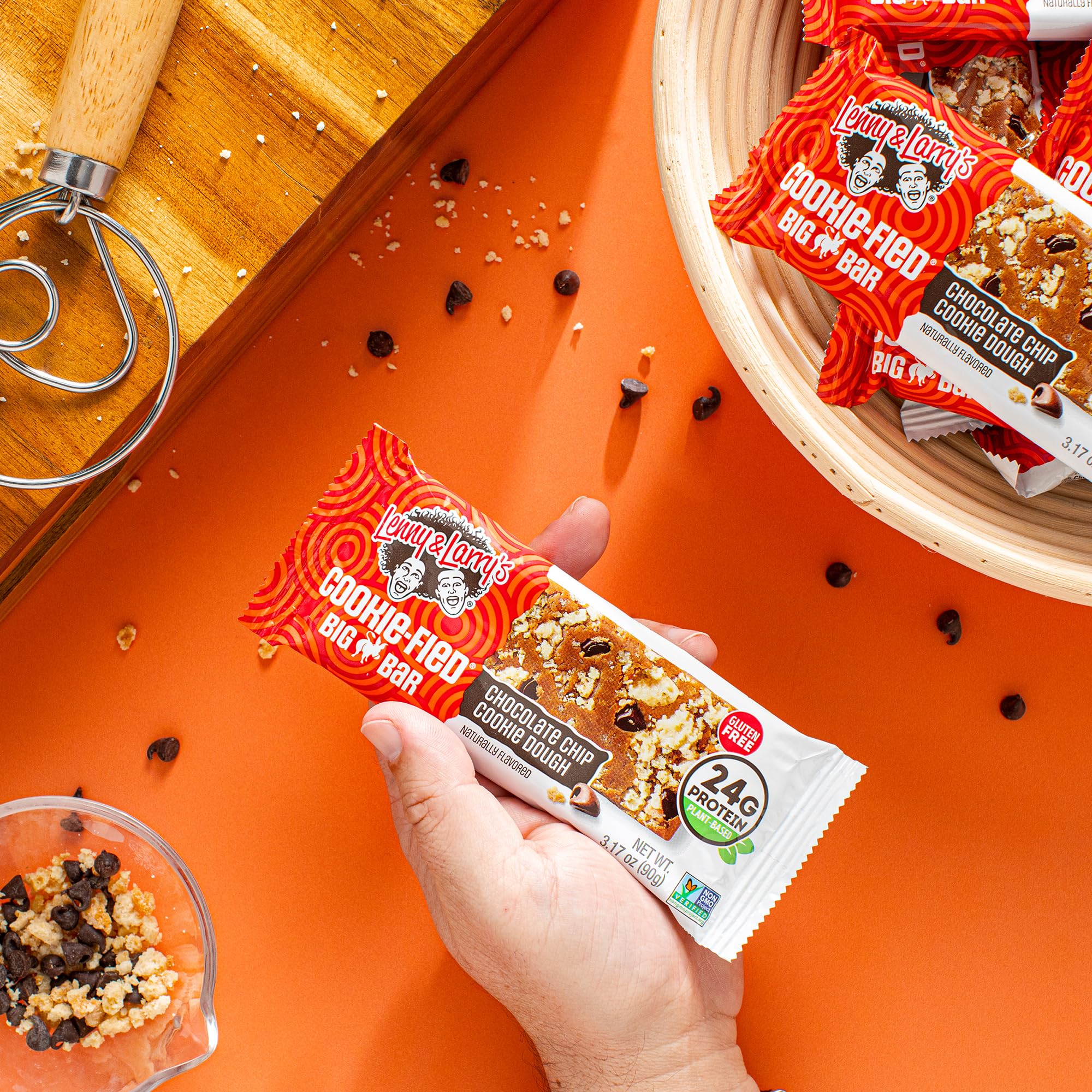 Lenny & Larry's bar held in hand to show 90g size and portion, demonstrates filling portion benefit