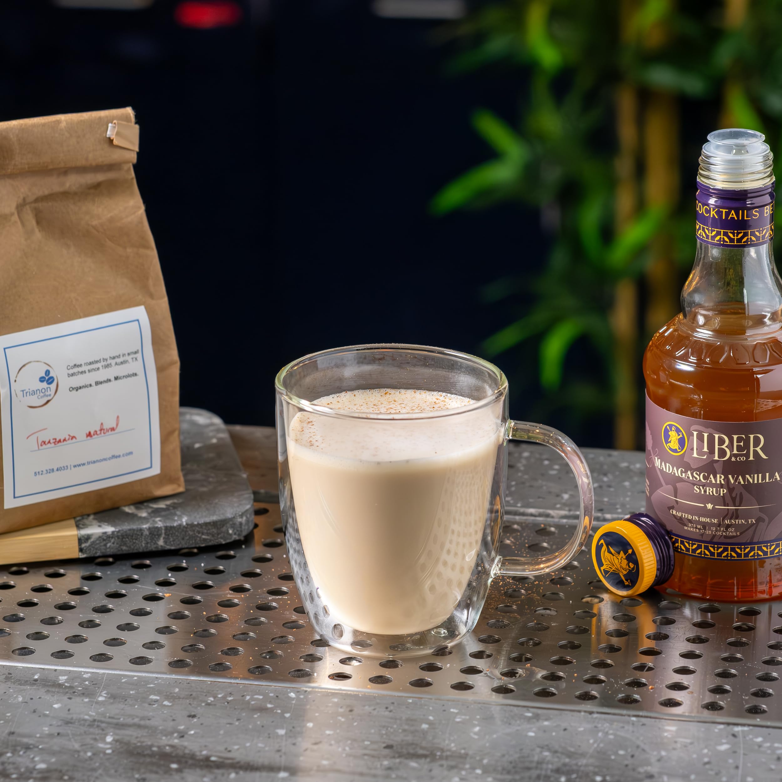 Latte with Liber & Co. vanilla syrup being stirred demonstrating richer coffee flavor benefit