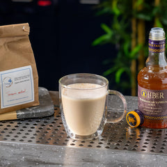 Latte with Liber & Co. vanilla syrup being stirred demonstrating richer coffee flavor benefit