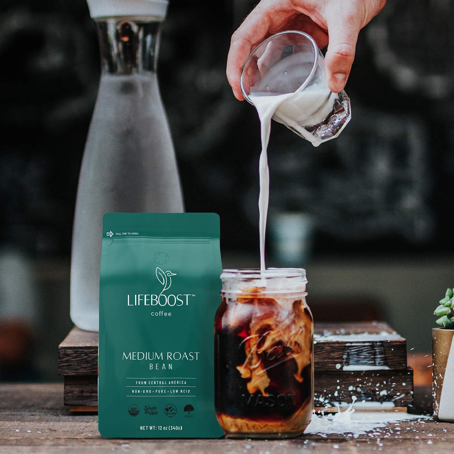 Lifeboost bag opened pouring beans into scoop showing freshness preserved