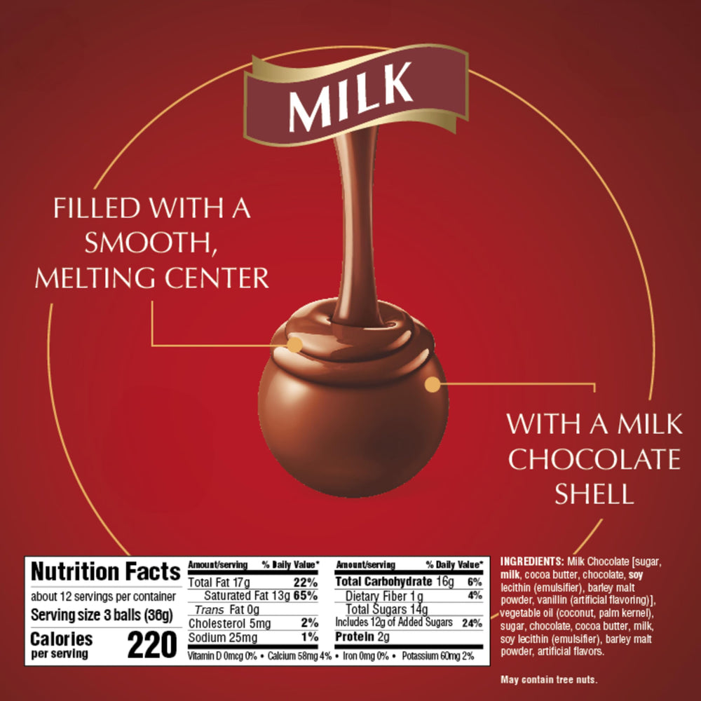 Lindt LINDOR truffle held in hand showing size and single-serve convenience