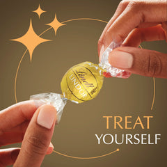 Lindt LINDOR truffle cutaway revealing melting center benefit: creamy, melt‑in‑the‑mouth filling