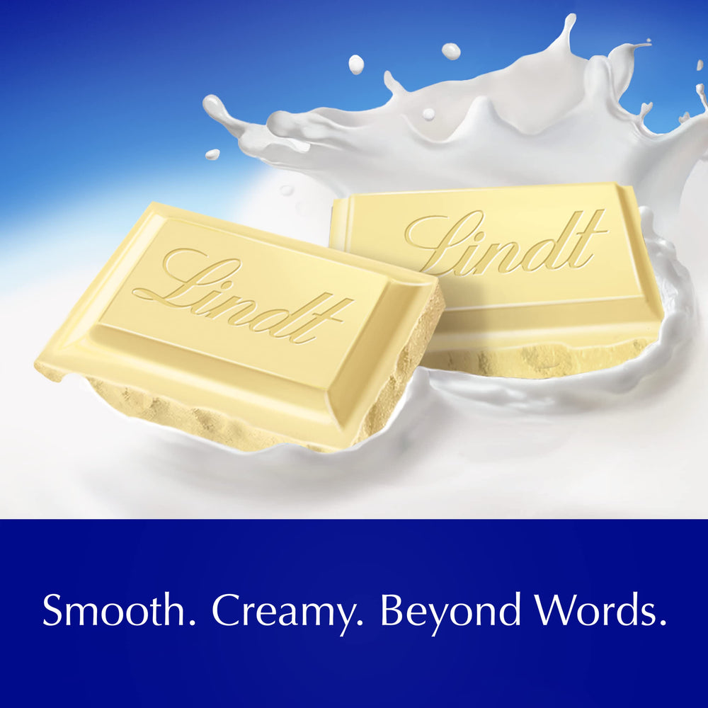 Hand holding Lindt white chocolate bar showing scale and convenient size