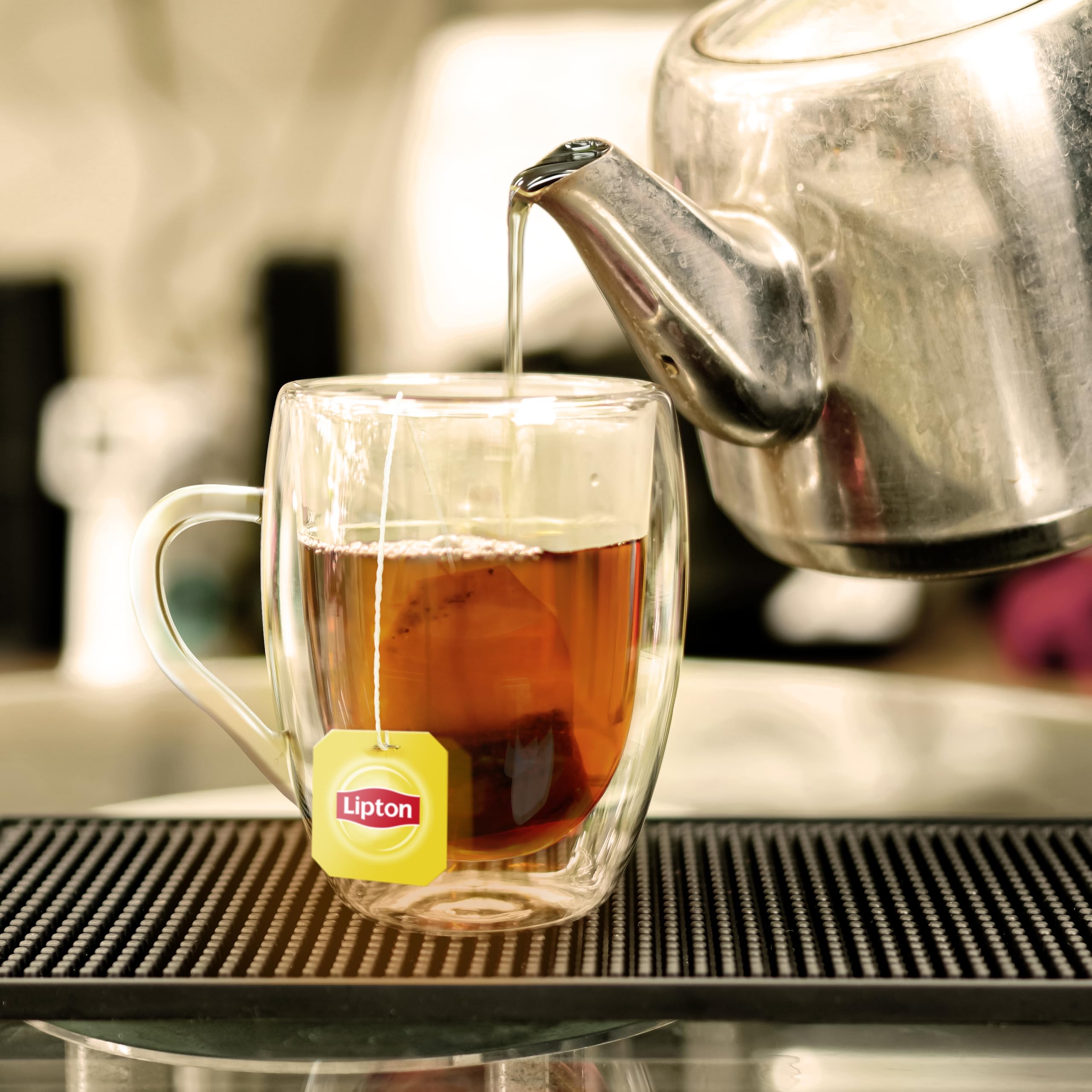 Lipton pitcher of iced tea in glass with ice showing refreshing serve