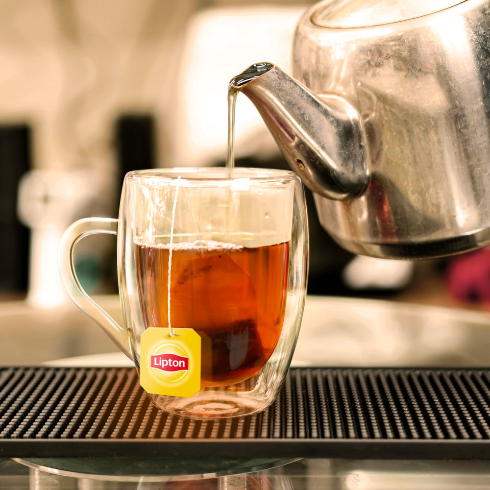 Lipton pitcher of iced tea in glass with ice showing refreshing serve