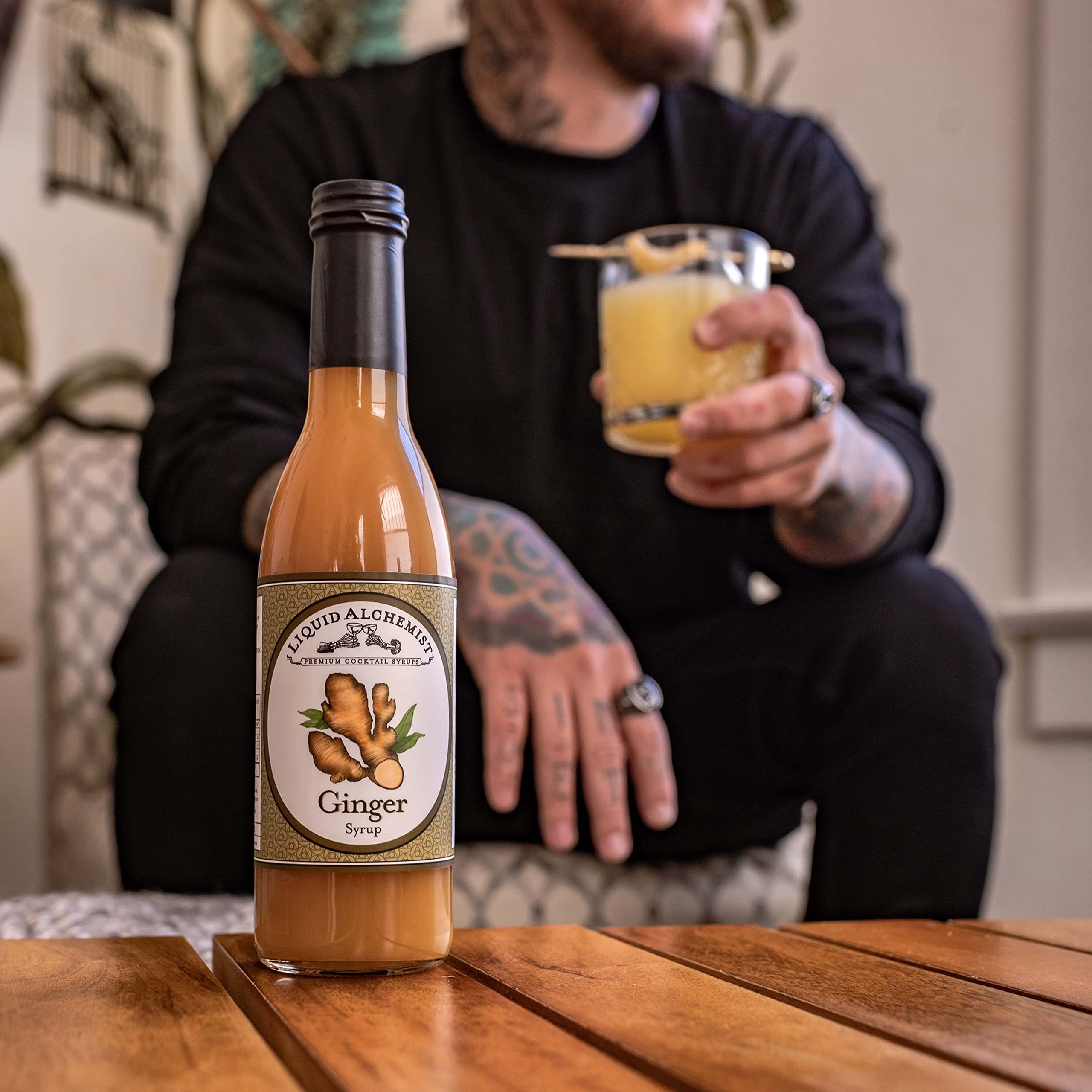 Liquid Alchemist bottle in a summer patio setting, suggesting entertaining convenience