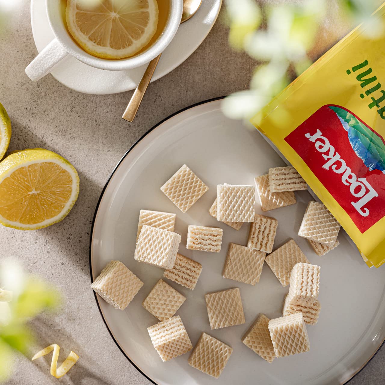 Loacker Quadratini Lemon on picnic table with friends showing shareable party snack benefit