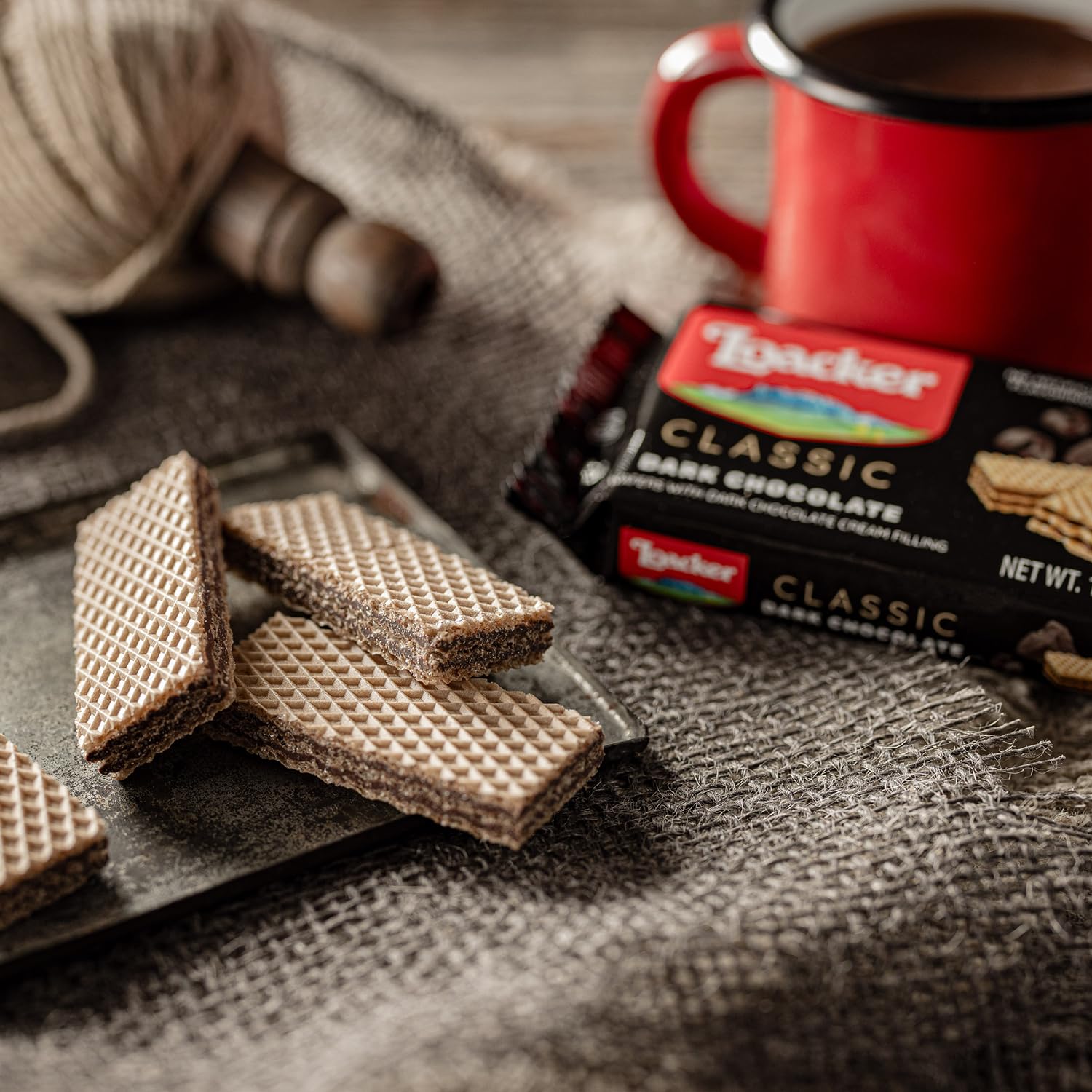 Hand holding Loacker wafer to show size, quick grab-and-go snack benefit