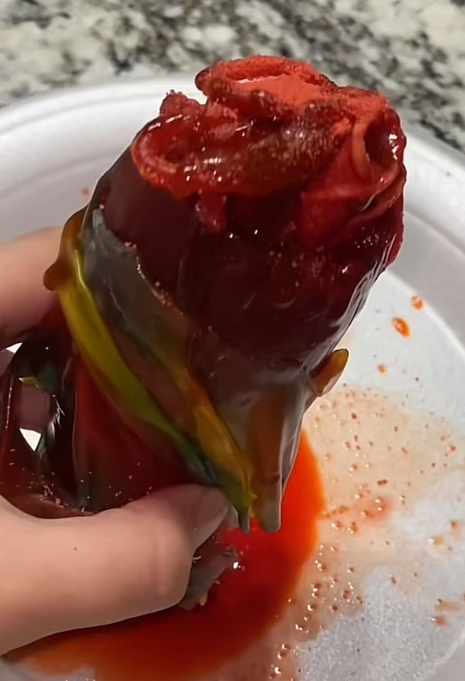 LookOn hand holding pickle coated with candy powders illustrating easy preparation