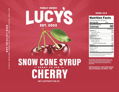 Snow cone topped with Lucy's cherry syrup in hand showing vibrant color and refreshing dessert enjoyment
