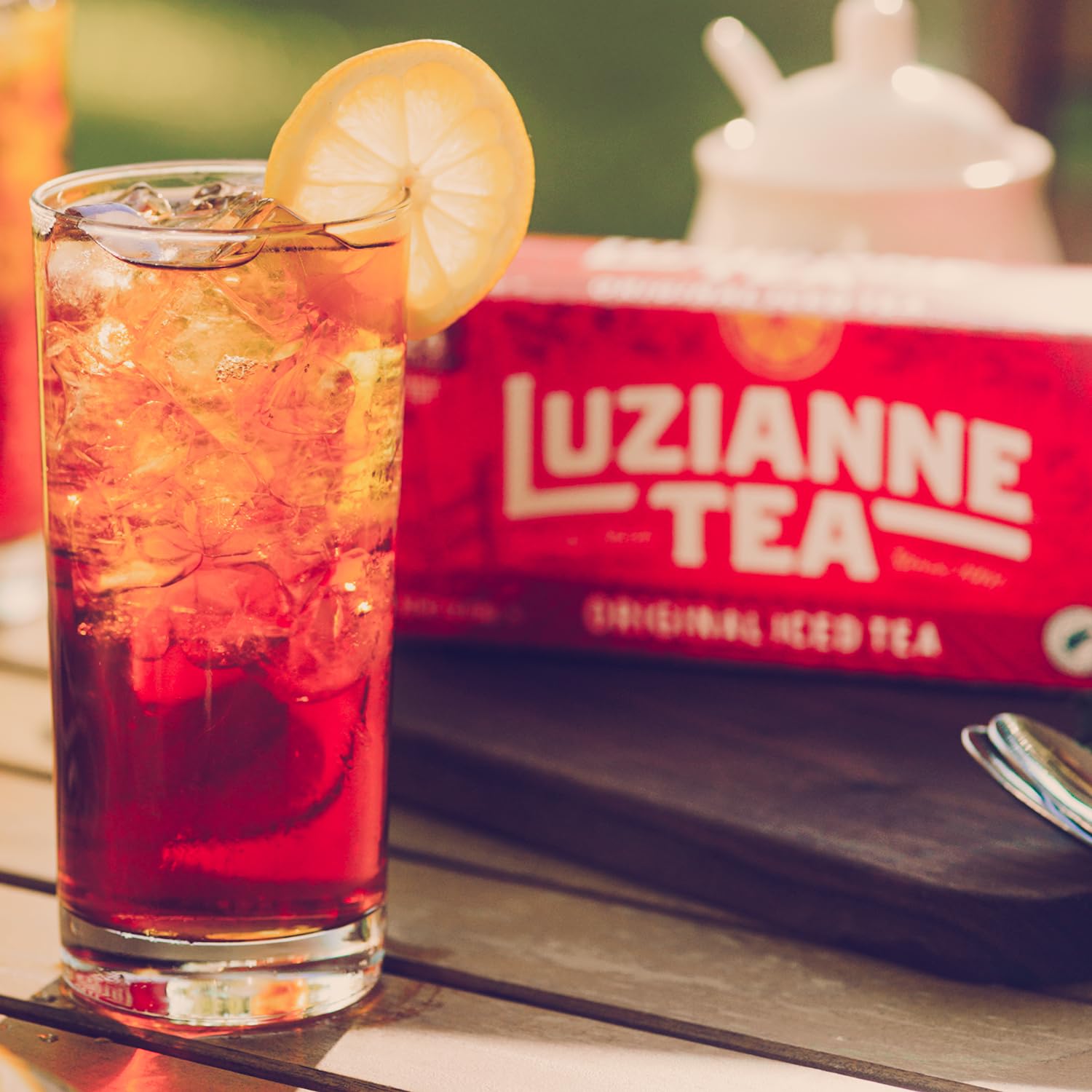 Pitcher of Luzianne iced tea with ice and lemon, refreshing drink ready to serve