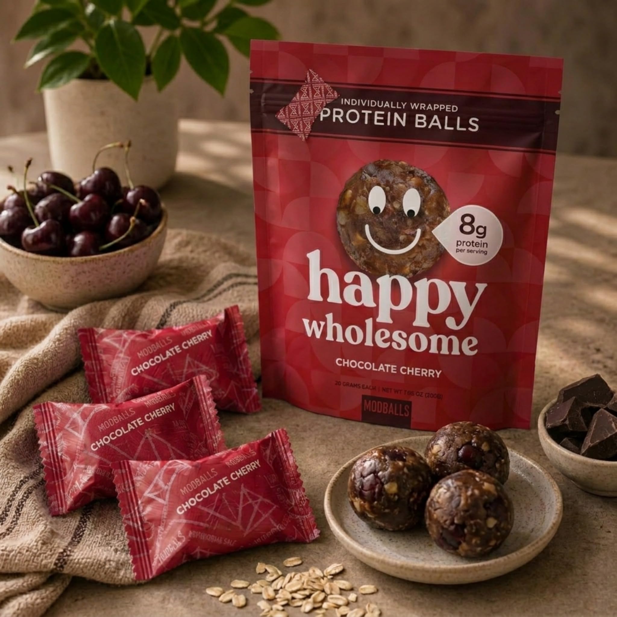 M MODBALLS served with oats and cherries showing natural ingredients benefit