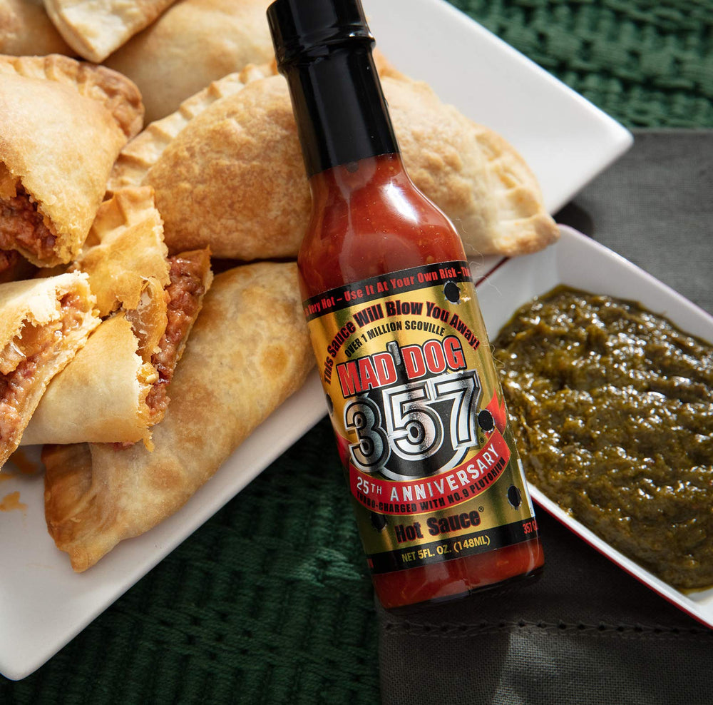 Mad Dog Gear next to a 5 oz measuring cup showing compact bottle size