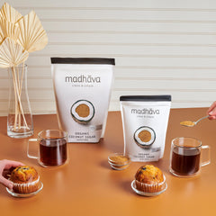 Madhava bag opened with spoon scooping sugar demonstrating easy portioning and use