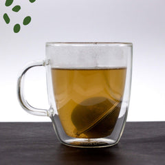 Pouring MagJo dandelion root into teapot demonstrating simple infusion preparation