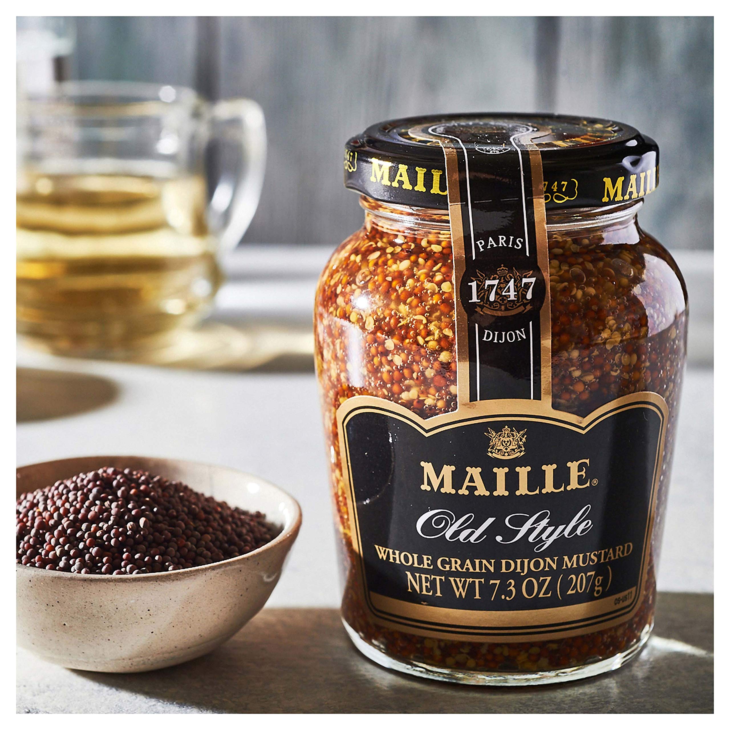 Maille Old Style on serving board with charcuterie adding rustic accent