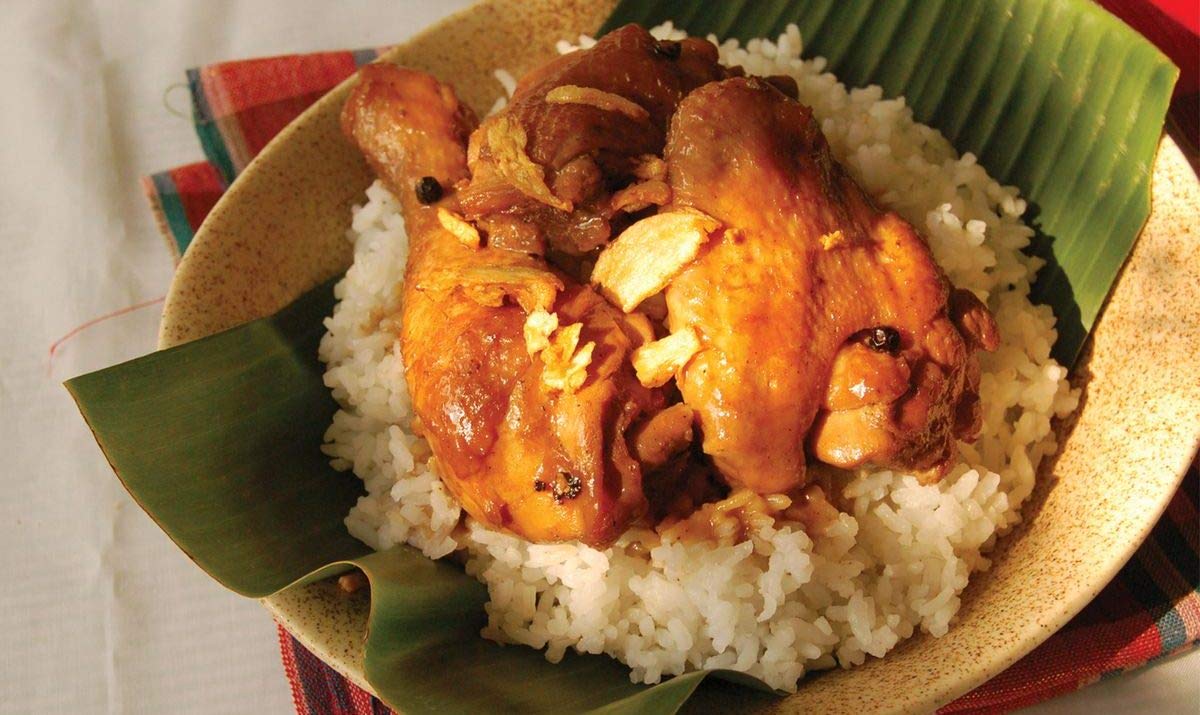 Mama Sita's adobo chicken on plate in a home setting, flavorful family meal