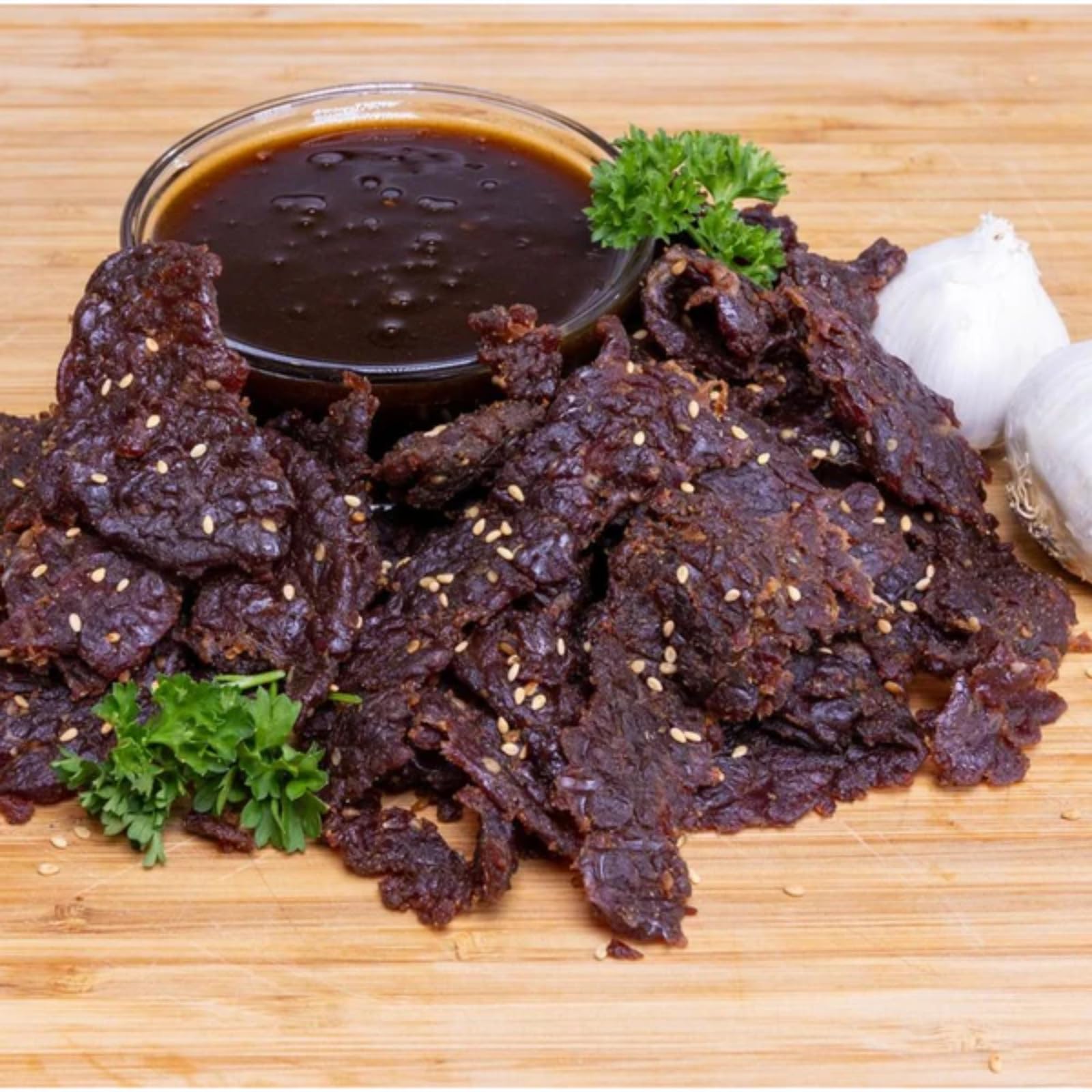 Man Candy jerky served on a wooden board showcasing smoky-sweet pieces for sharing