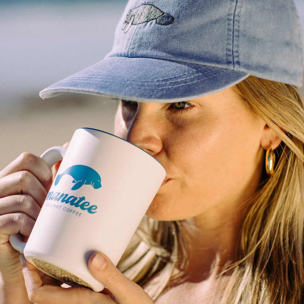 Manatee Gourmet Coffee lifestyle mug poured with coffee and pods showing convenience benefit